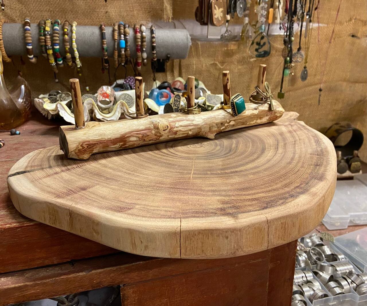 Finished display: live-edge slab base with a branch ring stand, in a friend's jewellery shop
